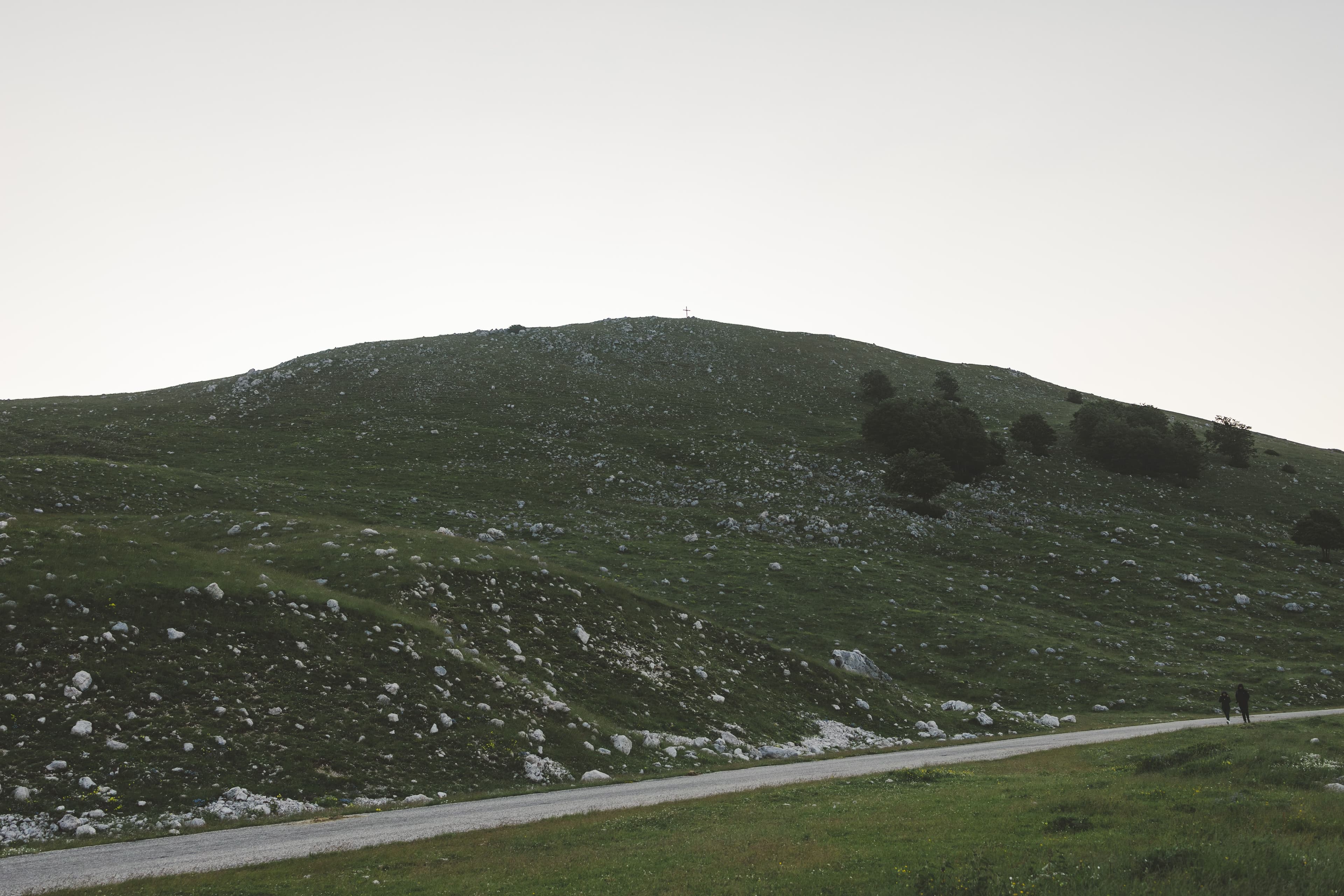 Stones and landscaping on a green hillside, similar to sloped lots around Hot Springs, AR