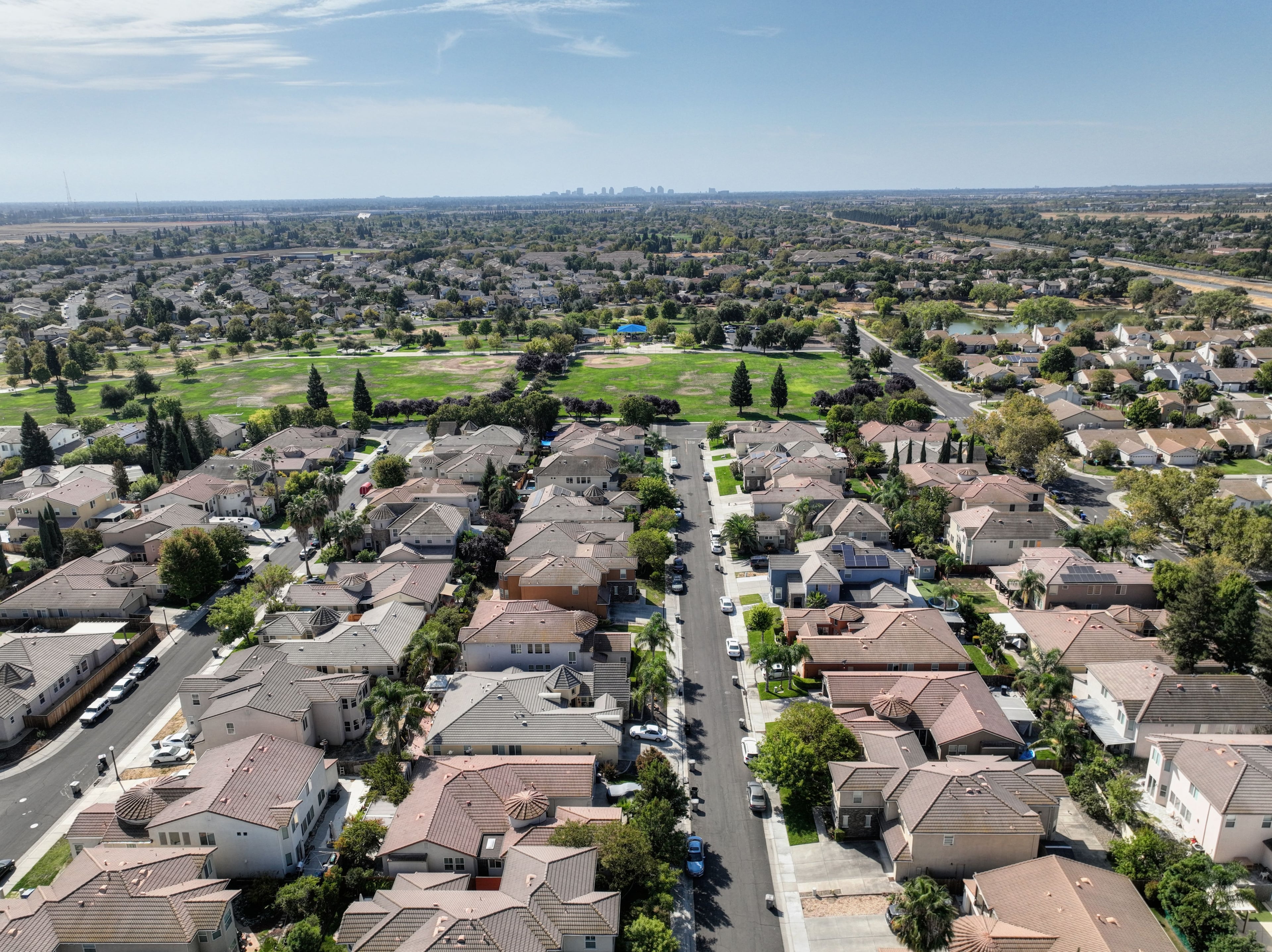 Aerial view of a growing suburban neighborhood, similar to Conway, AR's new subdivisions
