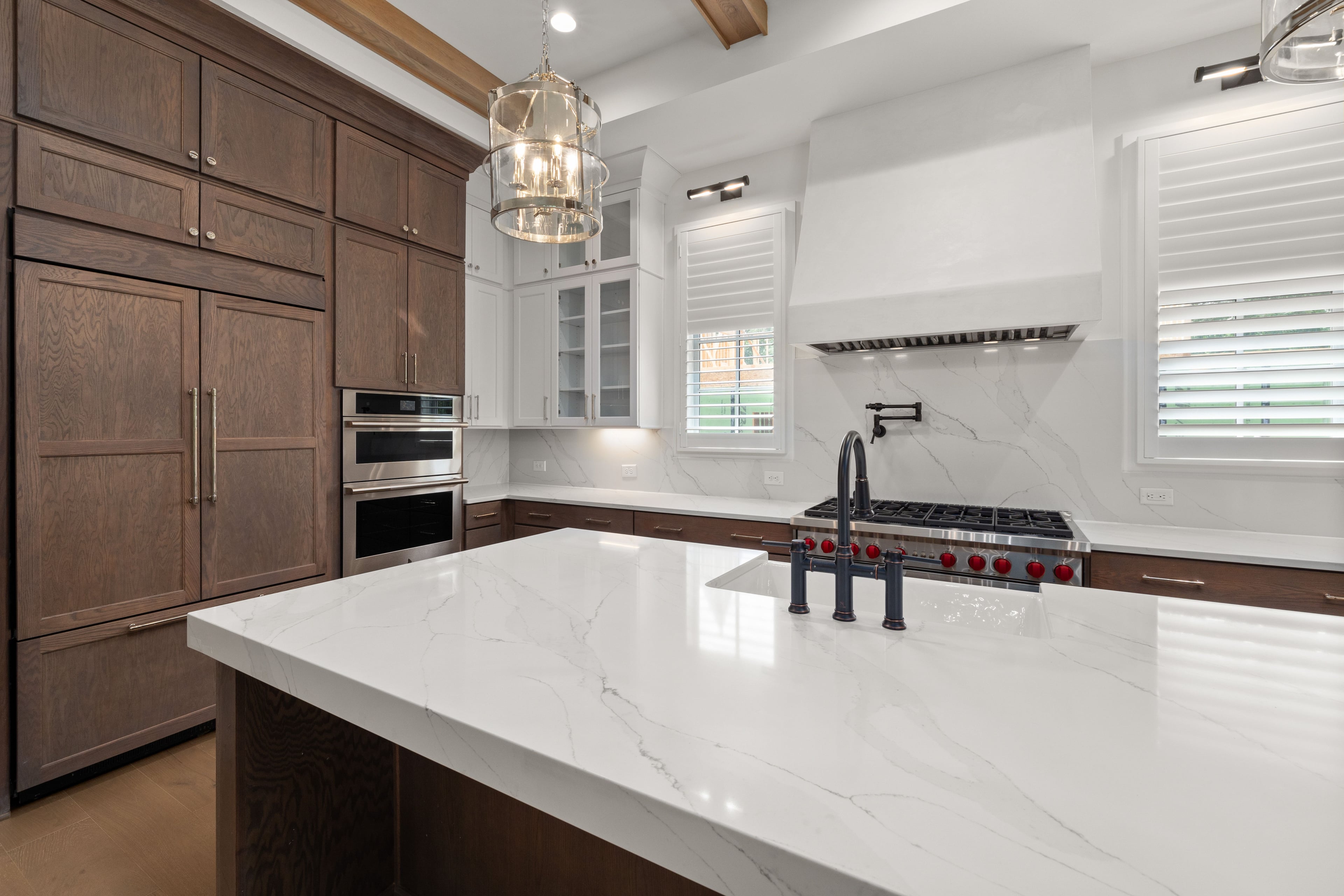 Elegant new-construction kitchen with marble island and stainless steel appliances in St. Johns, FL