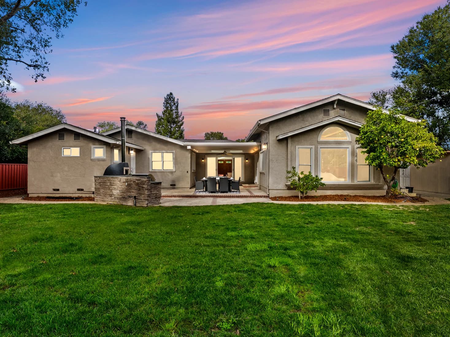 House and backyard lawn at twilight, 1941 Deodara Drive in Los Altos, photographed by San Jose Real Estate Photos