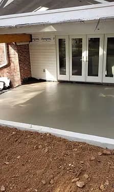 Freshly poured concrete patio beside French doors — Lehigh Valley